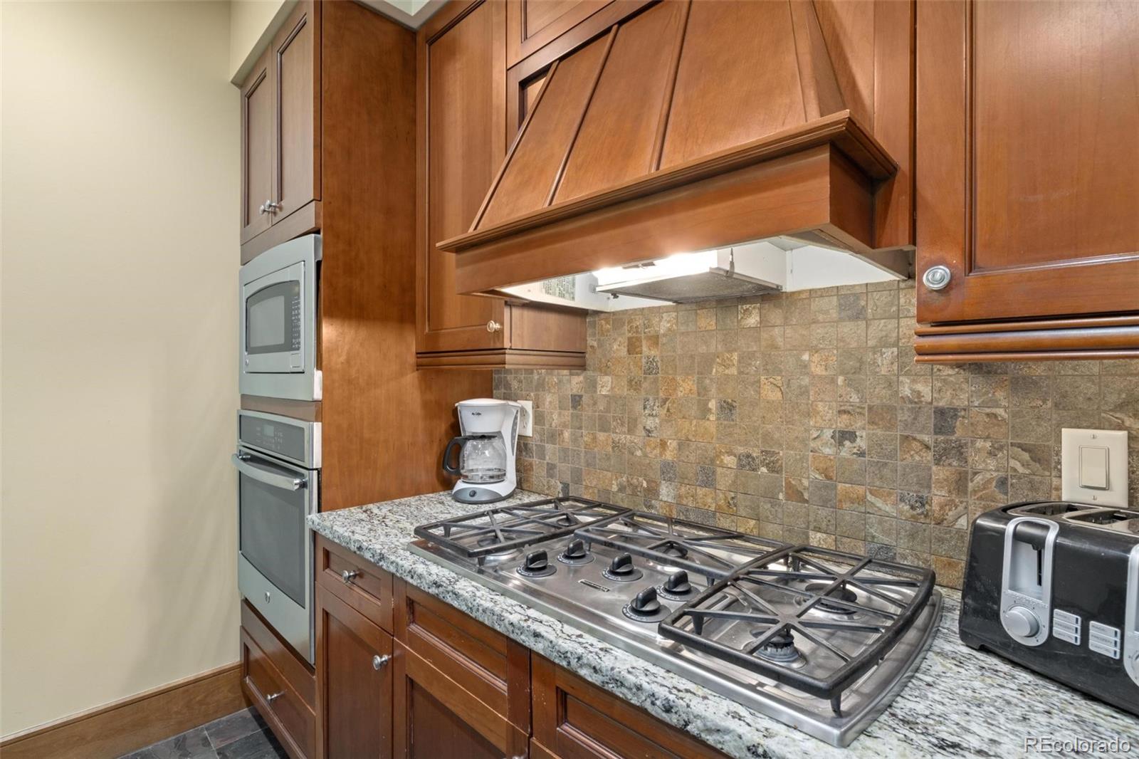 280 Trailhead Drive, Unit 3003 Dillon, CO 80435 - Photo 11 of 27 a stove top oven sitting inside of a kitchen