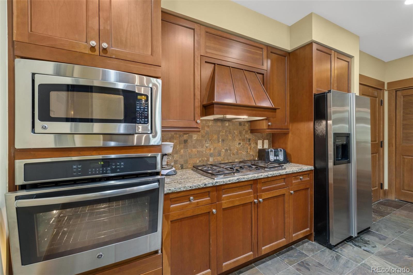 280 Trailhead Drive, Unit 3003 Dillon, CO 80435 - Photo 10 of 27 a kitchen with granite countertop cabinets stainless steel appliances and a counter space
