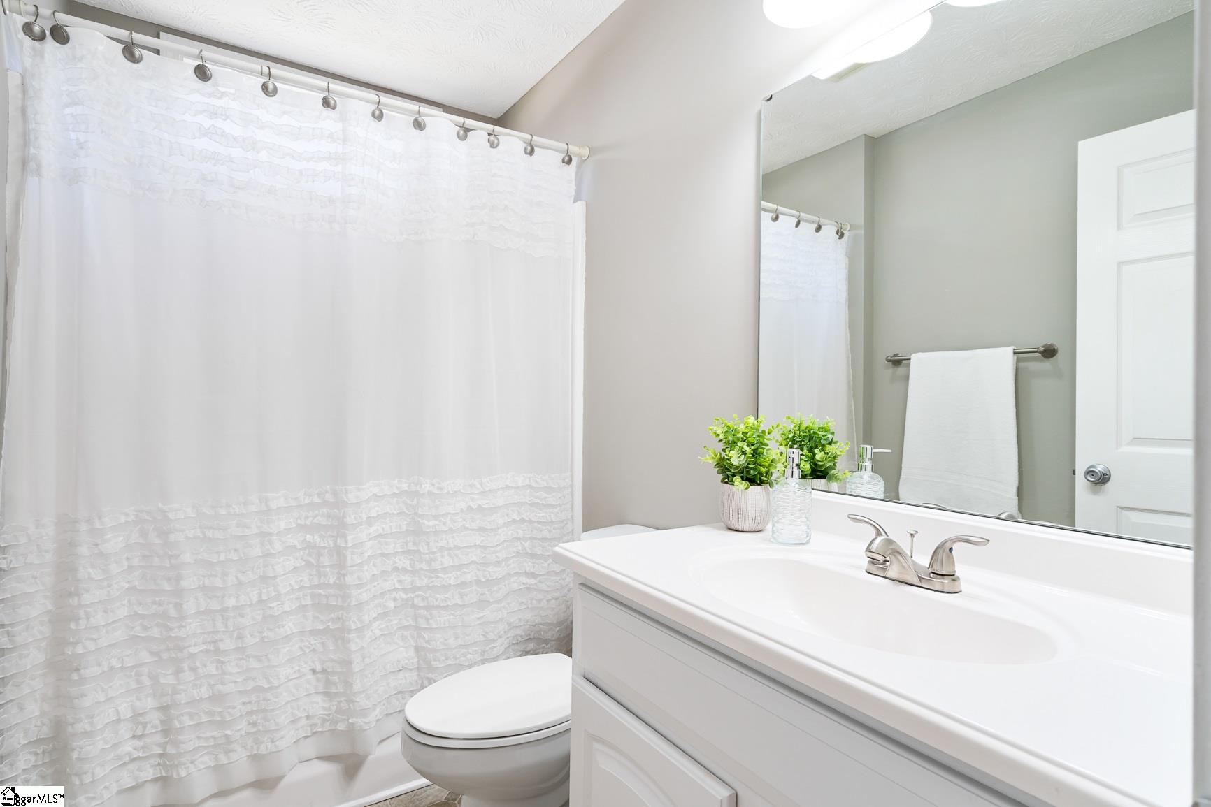 428 McAlister Road Williamston, SC 29697 - Photo 22 of 33 This bathroom is to the right side of the home between bedroom 2 and 3 and is off from the living room- It has a tub shower combo 4.9 x 5