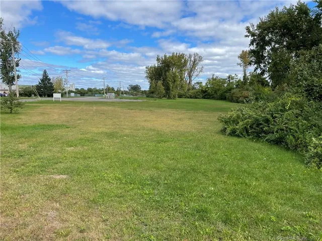 a view of a field with an ocean