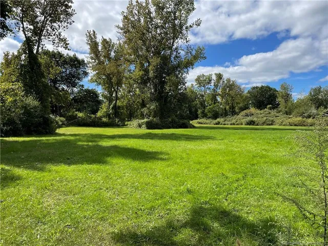a view of a green field with sitting space