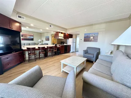 a living room with furniture and a wall painting