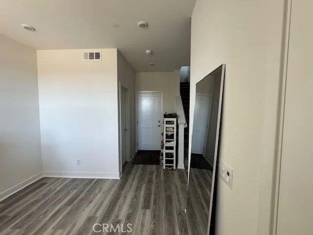 a view of hallway with wooden floor