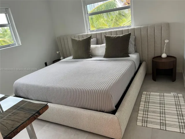 a bed sitting in a bedroom next to a window