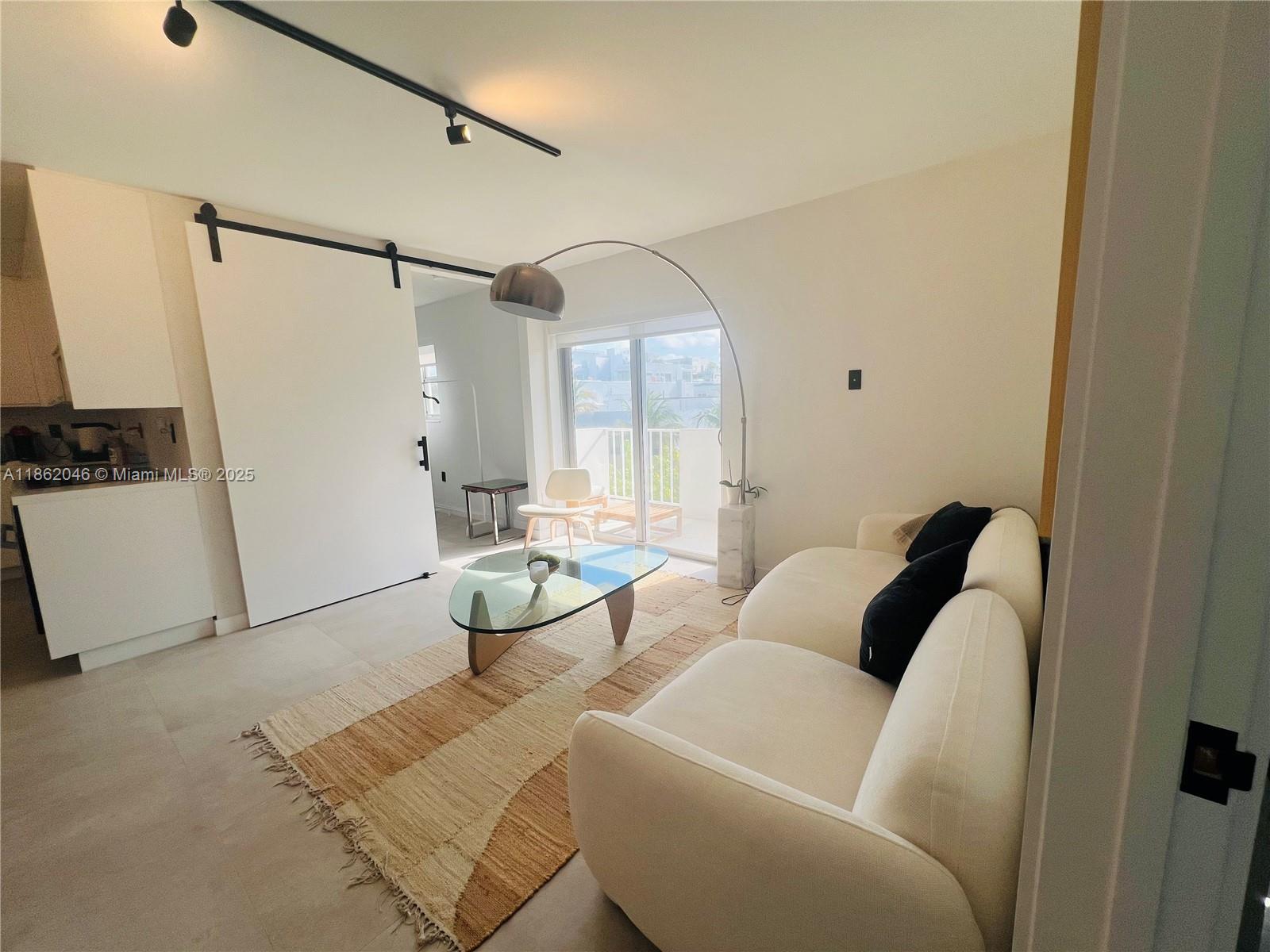 240 Collins Avenue, Unit 4A Miami Beach, FL 33139 - Photo 4 of 16 a living room with furniture and a window