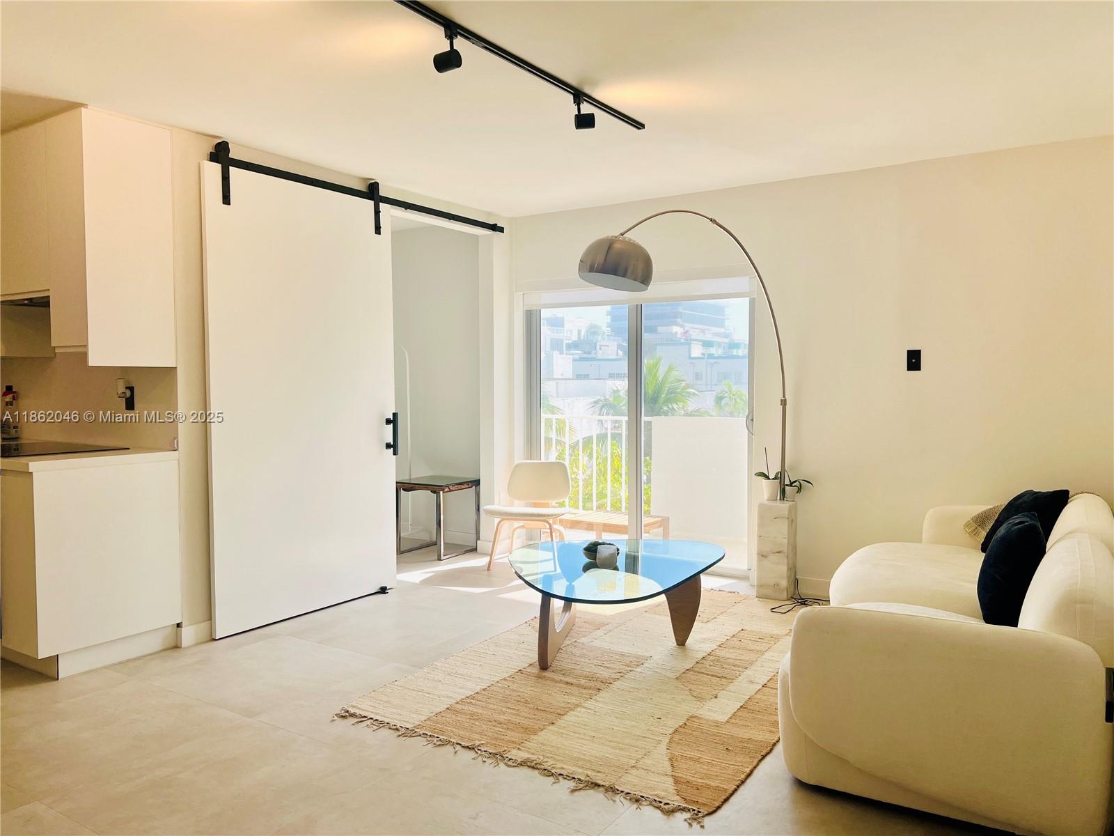 240 Collins Avenue, Unit 4A Miami Beach, FL 33139 - Photo 7 of 16 a living room with furniture and a window