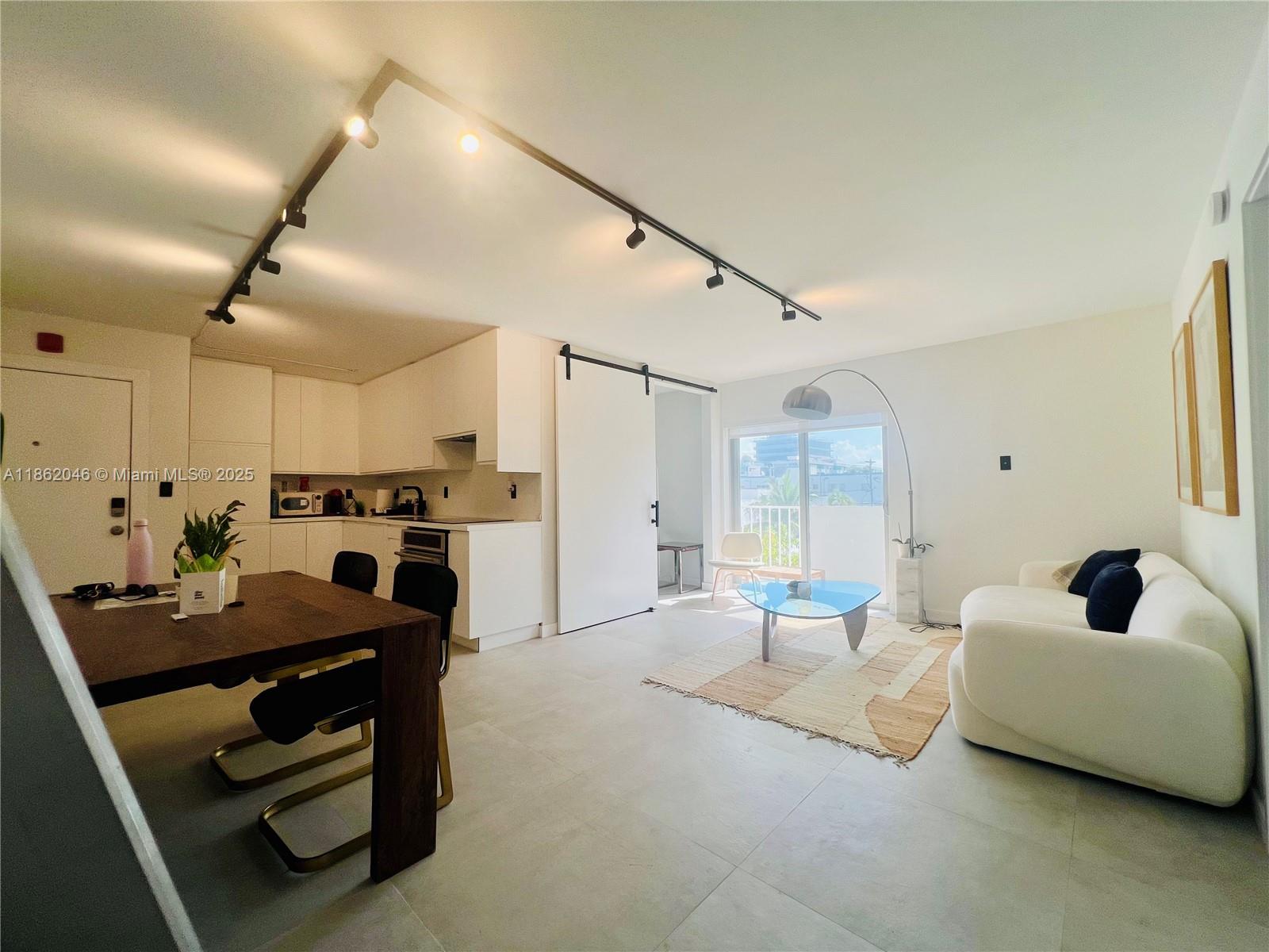 240 Collins Avenue, Unit 4A Miami Beach, FL 33139 - Photo 8 of 16 a living room with furniture and a large window