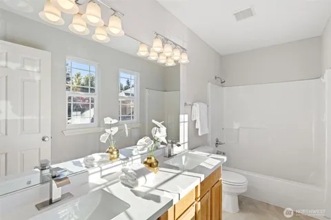 a view of a dining room with furniture a chandelier and window