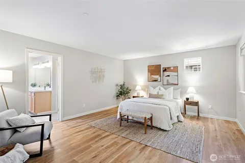 a bedroom with a bed and wooden floor