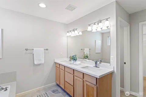 a bathroom with a sink a mirror and a light fixture