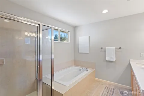 a bathroom with a tub shower and sink
