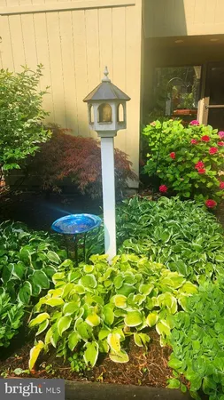 a front view of a house with a yard and fountain