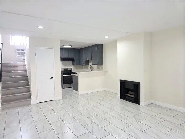 a view of a kitchen with electric appliances and cabinets