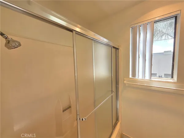 a bathroom with a glass shower door