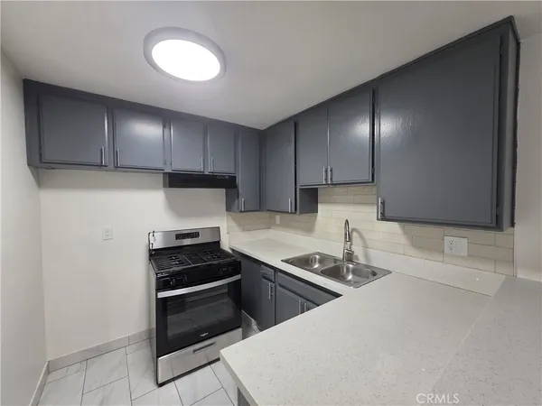 a kitchen with cabinets and appliances