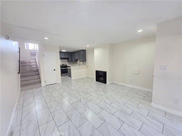 a view of kitchen with refrigerator cabinets and microwave