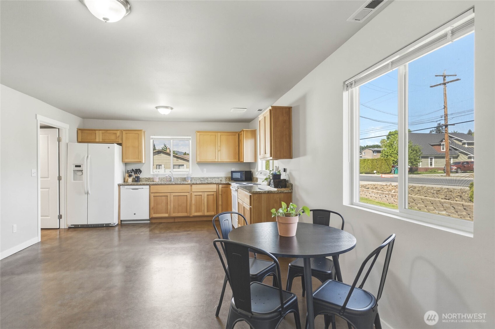 25 Sun Valley Drive Wenatchee, WA 98801 - Photo 10 of 27 a kitchen with a table chairs refrigerator and cabinets