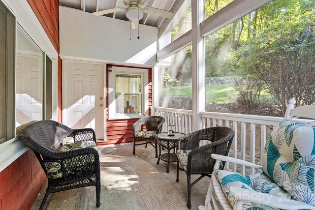 a living room with furniture and floor to ceiling windows