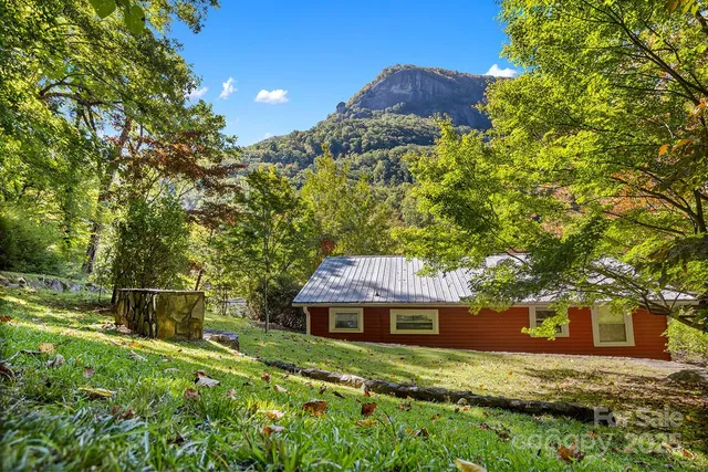 a view of house with a yard