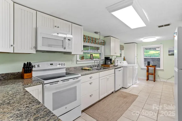 a kitchen with cabinets and window