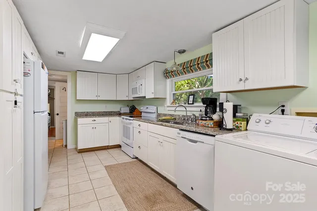 a kitchen with a white cabinets and white appliances