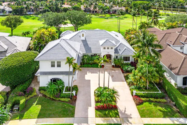 a aerial view of a house with a yard and plants