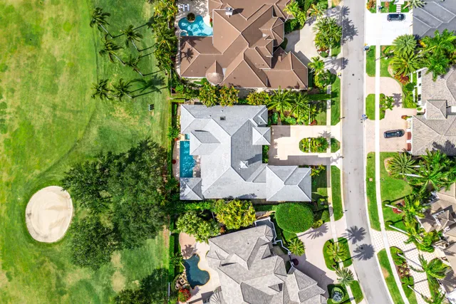 an aerial view of a house with garden space and street view