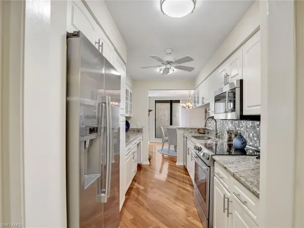 a large bedroom with a bed and flat screen tv