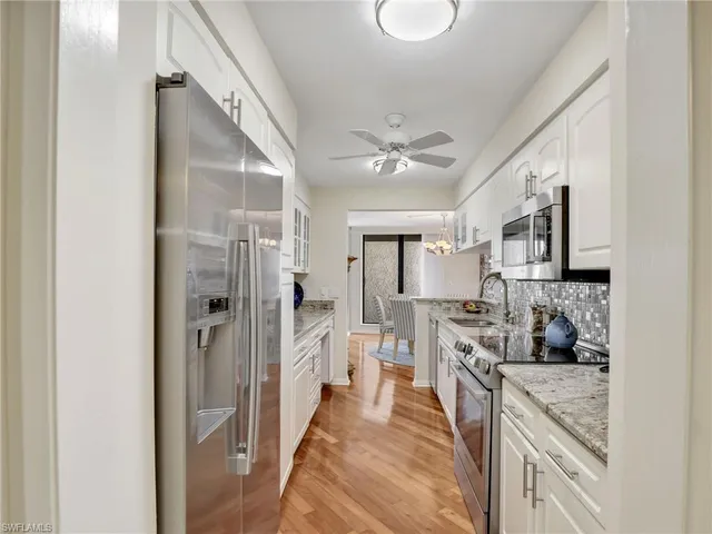 a large bedroom with a bed and flat screen tv