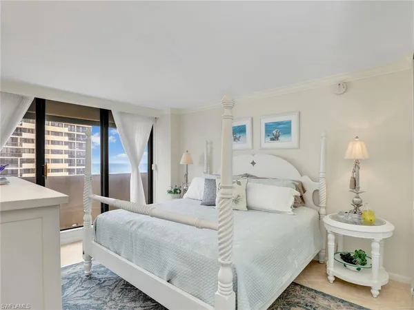 a spacious bedroom with a bed and a dresser