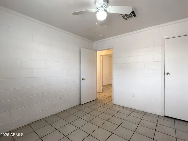 en empty room with fan and glass door