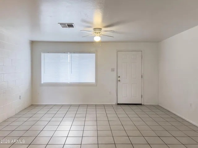 a view of a kitchen with a sink and dishwasher a refrigerator with white cabinets