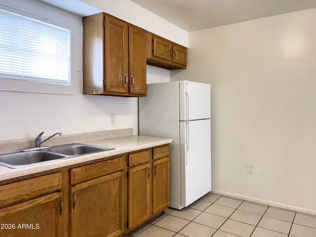 a kitchen with stainless steel appliances granite countertop a sink cabinets and a window