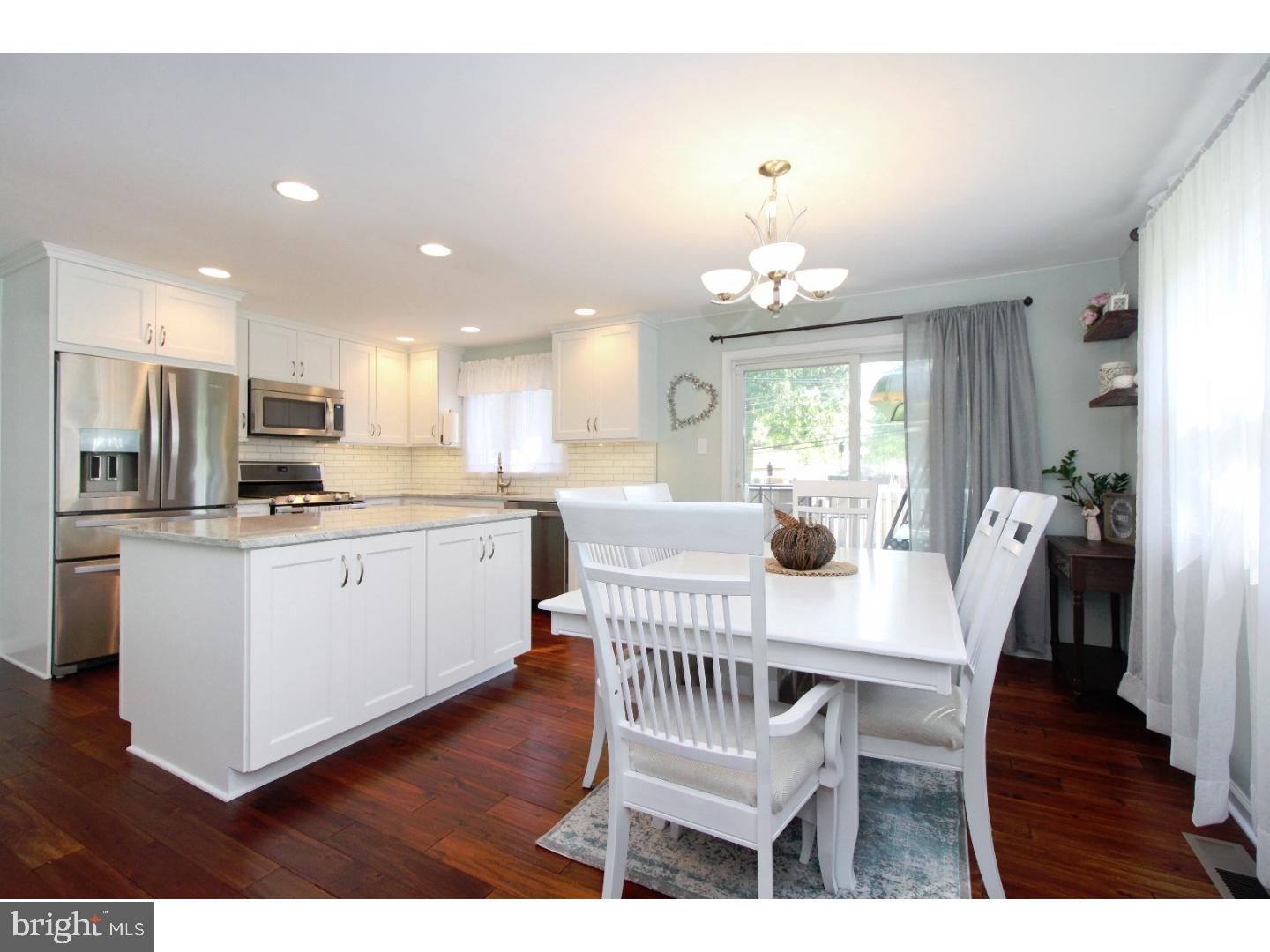 735 Rhoads Drive Springfield, PA 19064 - Photo 1 of 25 a kitchen with stainless steel appliances a dining table and chairs