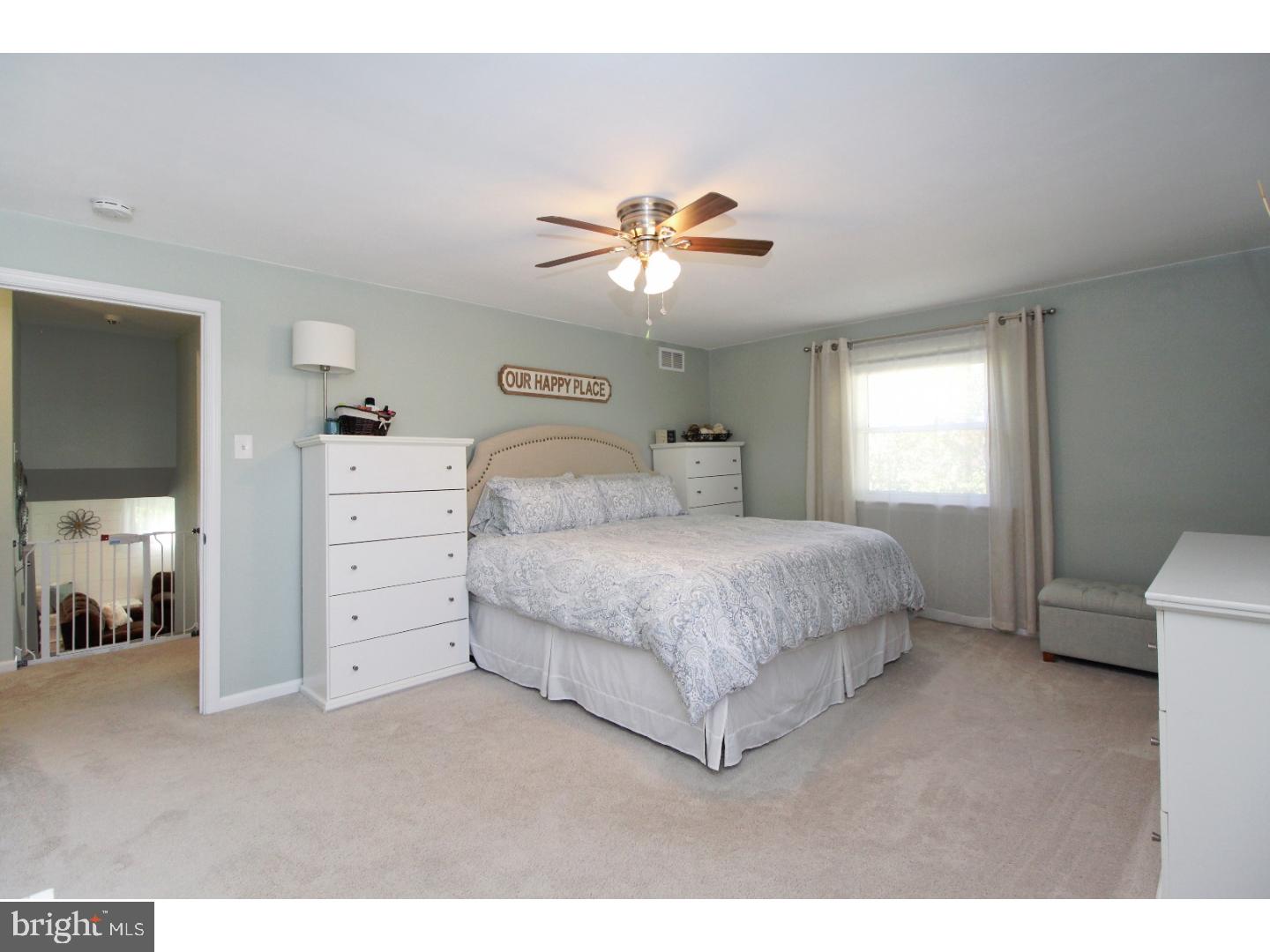 735 Rhoads Drive Springfield, PA 19064 - Photo 12 of 25 a bedroom with a bed and a chandelier