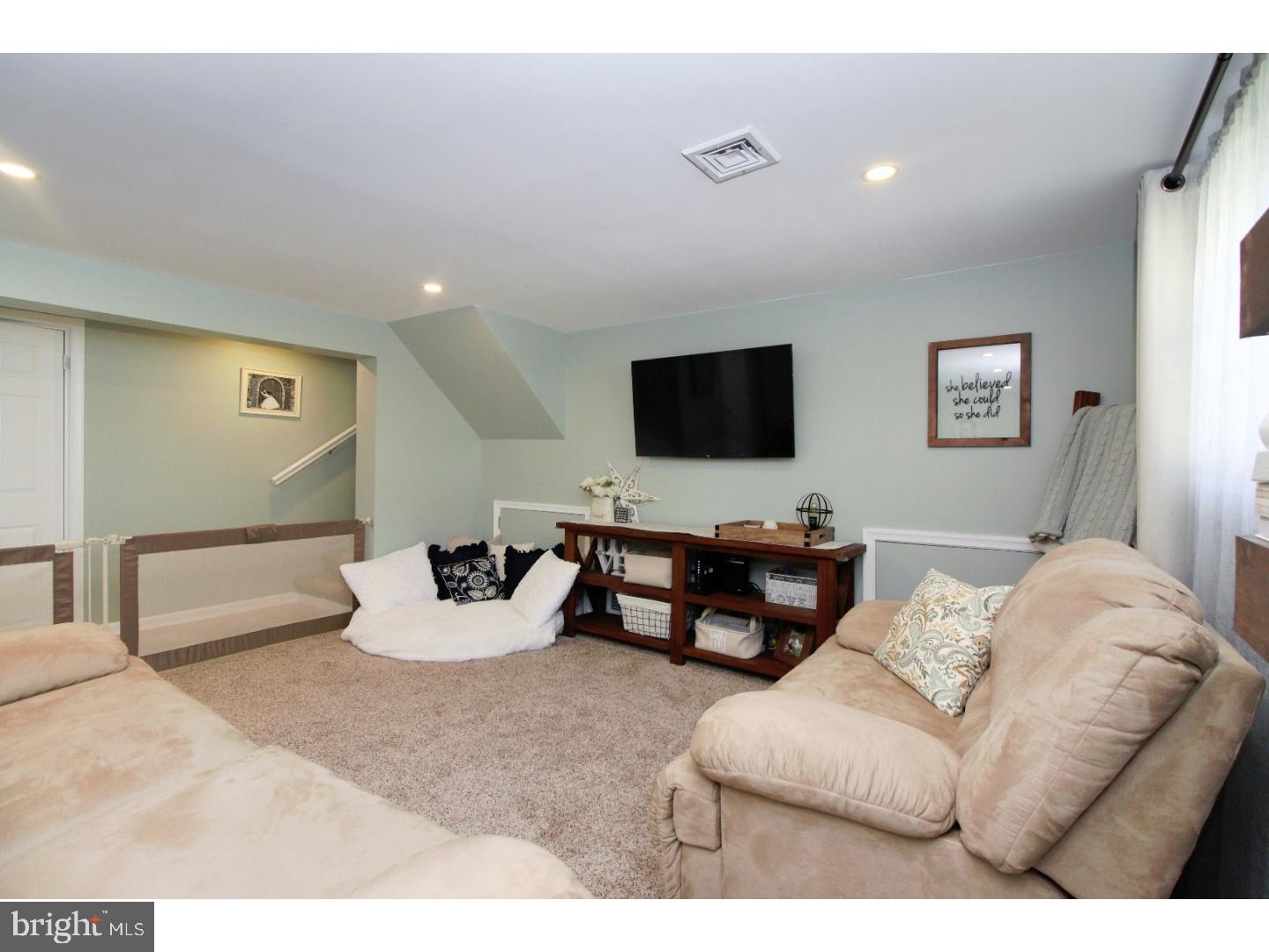 735 Rhoads Drive Springfield, PA 19064 - Photo 18 of 25 a living room with furniture and a flat screen tv