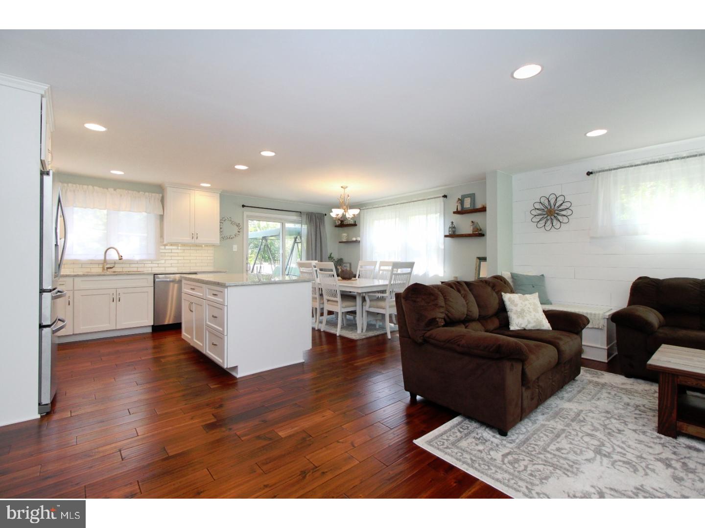 735 Rhoads Drive Springfield, PA 19064 - Photo 6 of 25 a living room with furniture and kitchen view with wooden floor
