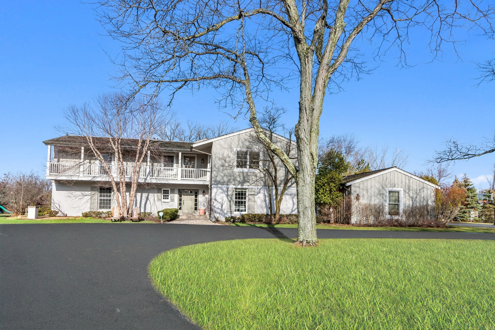 a view of multiple house with a yard and large trees