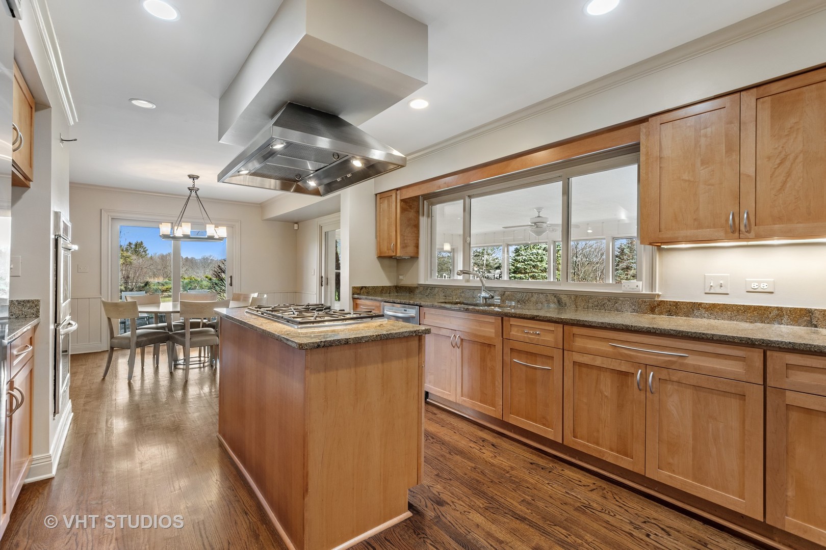 1850 South Ridge Road Lake Forest, IL 60045 - Photo 11 of 34 a kitchen with stainless steel appliances granite countertop a stove a sink dishwasher and a refrigerator with wooden floor