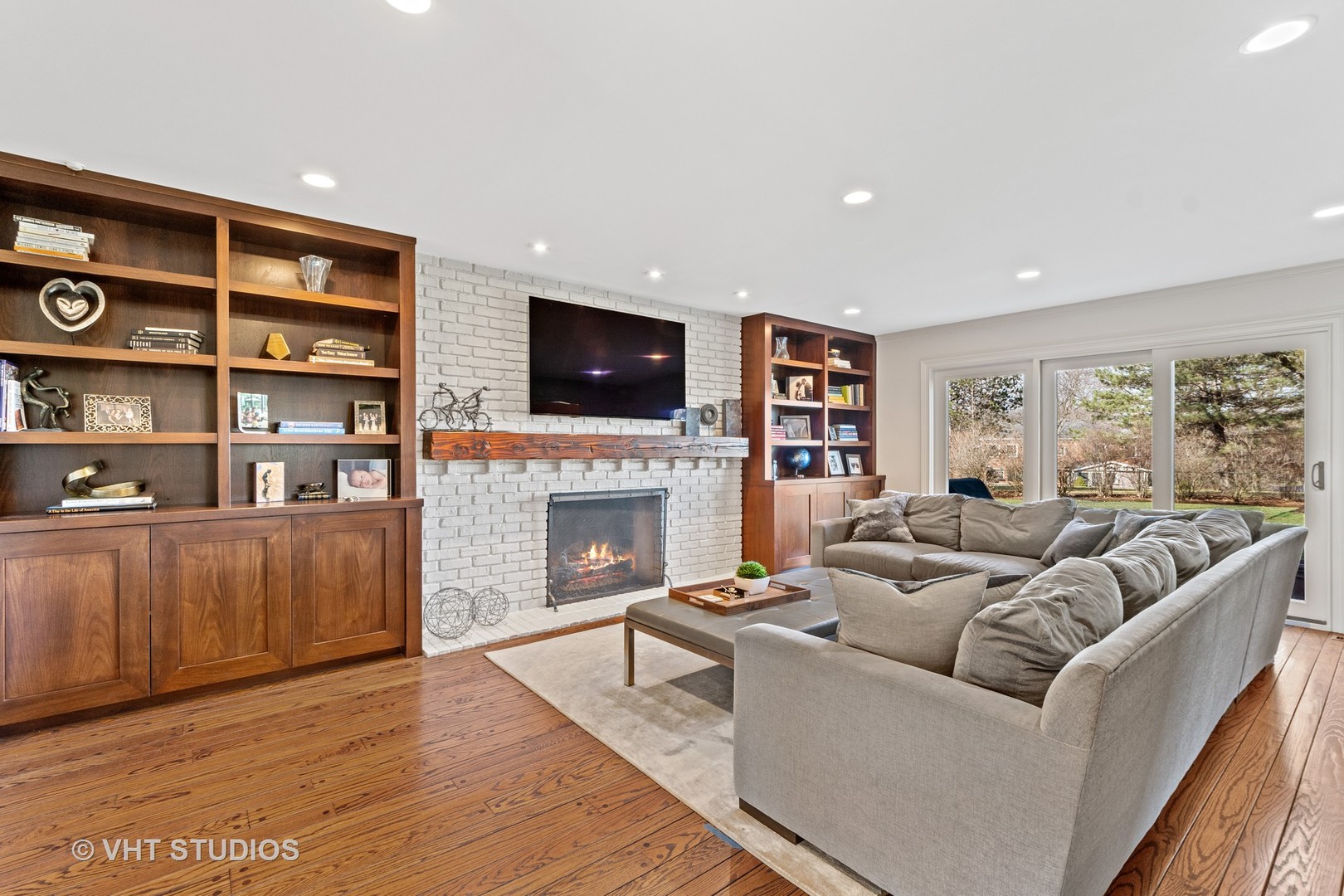 1850 South Ridge Road Lake Forest, IL 60045 - Photo 16 of 34 a living room with furniture a fireplace and a flat screen tv