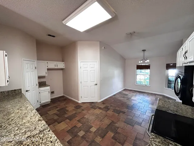 a view of a kitchen and window