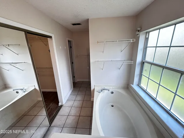 a bathroom with a bathtub and a window