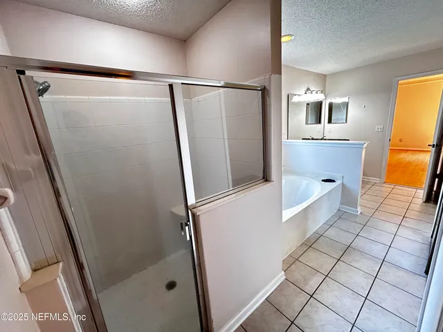 a bathroom with a glass door shower and toilet