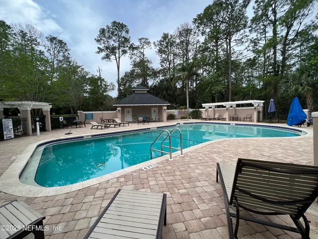 a view of house with swimming pool outdoor seating