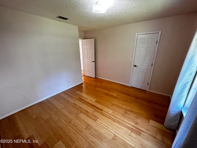 a bathroom with a granite countertop sink mirror vanity and toilet