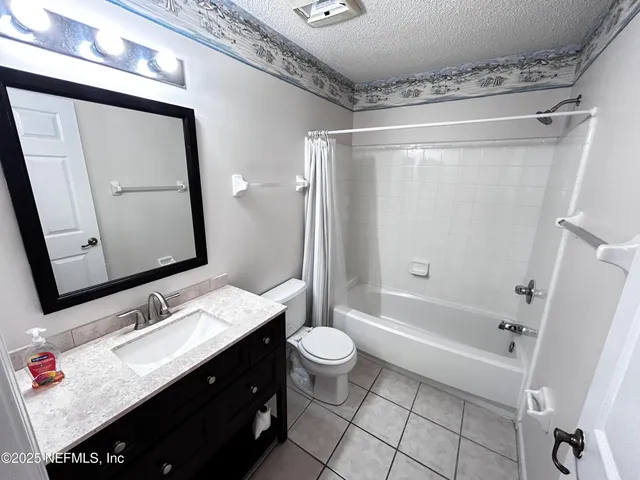 an empty room with a ceiling fan and wooden floor
