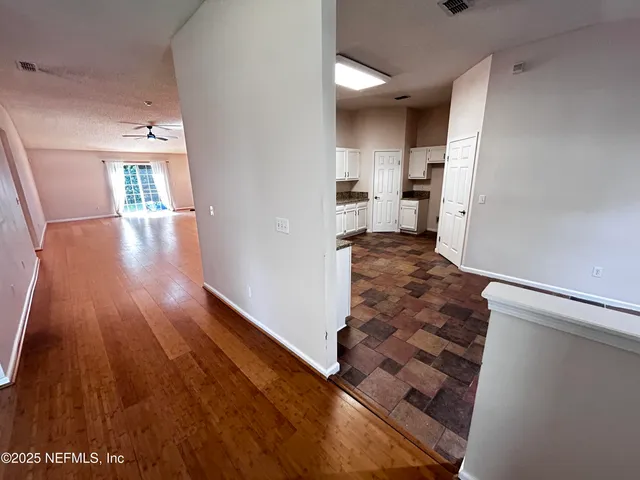a view of a living room with wooden floor