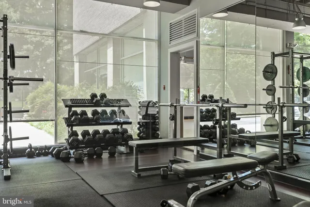 a room with gym equipment and next to a window