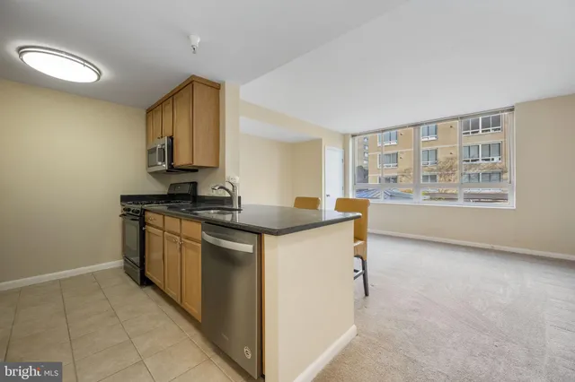 a kitchen with stainless steel appliances granite countertop a stove and a sink
