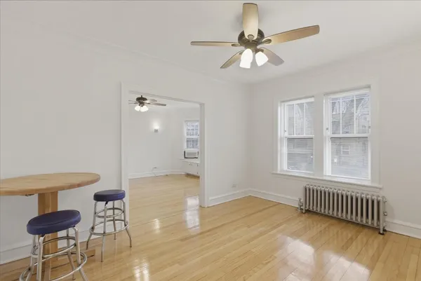 a view of a room with a window and wooden floor
